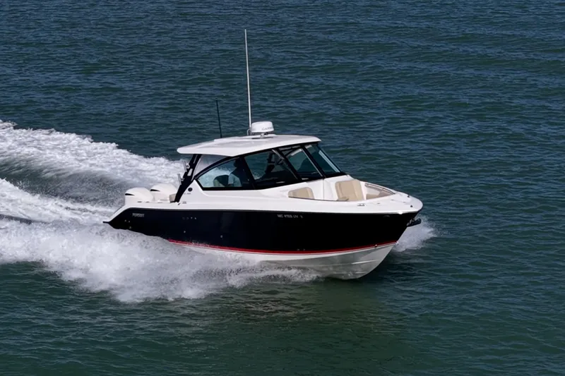 Slide: The Image of 2017 Pursuit DC 295 Dual Console boat cruising on open water. - 74