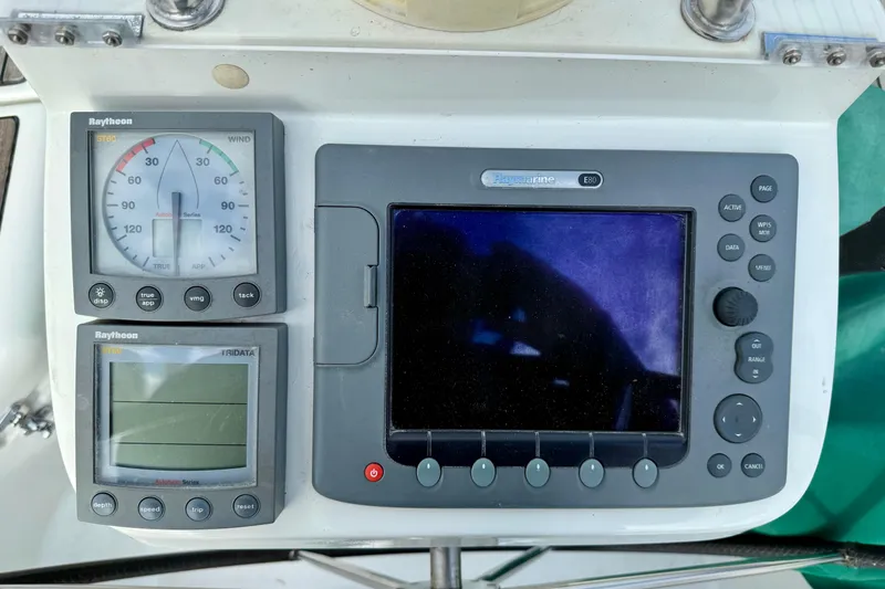 Slide: The Image of Beneteau 361 yacht navigation instruments, featuring Raytheon ST60 and Raymarine E80 displays. - 21