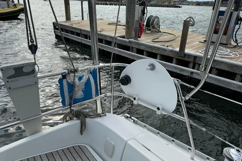 Slide: The Image of Sailboat Beneteau 361 (2000) docked, showing deck and railing details. - 24
