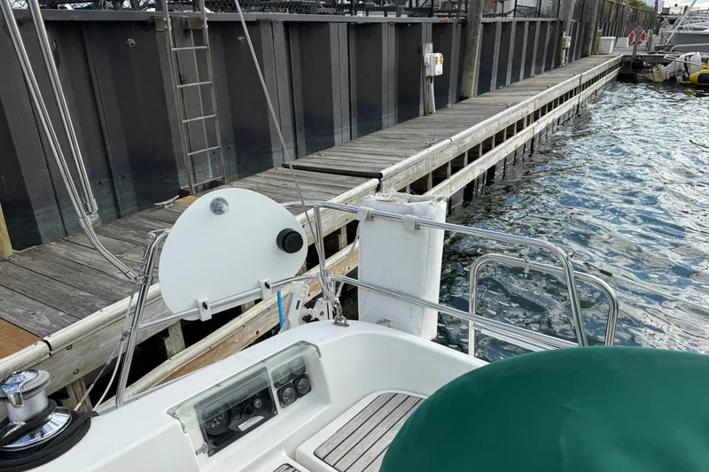 Slide: The Image of Beneteau 361 sailboat docked at marina, showcasing helm and deck details, year 2000 model. - 25