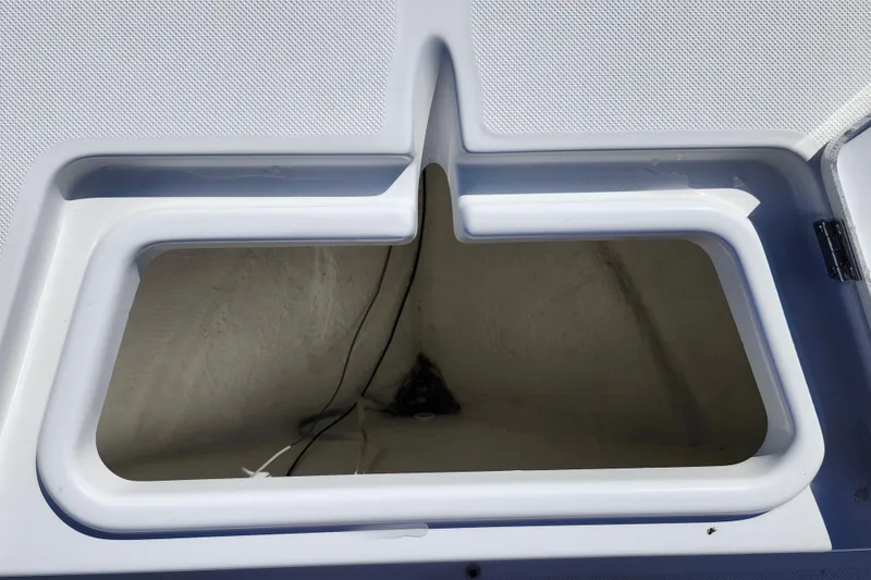 Slide: The Image of Open storage compartment on a 2026 Savannah 210X boat, featuring a clean, white interior. - 12