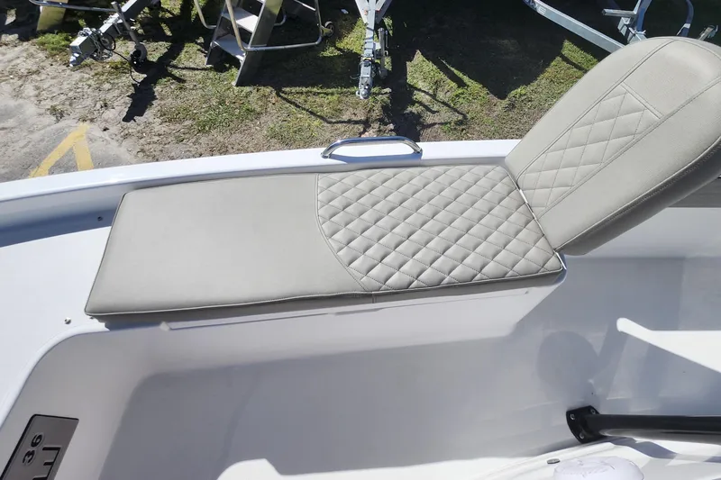 Slide: The Image of 2026 Savannah 210X boat seat with quilted gray upholstery, outdoor setting. - 13