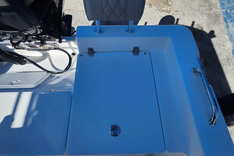 Slide: The Image of 2026 Savannah 210X boat deck with storage compartment and seat, featuring sleek design elements. - 23