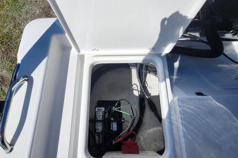 Slide: The Image of Open battery compartment of 2026 Savannah 210X boat, showing wiring and connections. - 29
