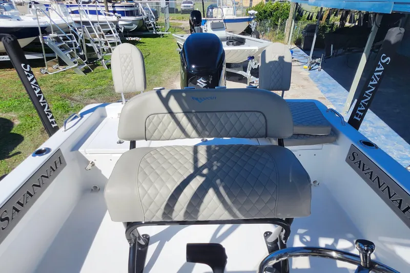 Slide: The Image of 2026 Savannah 210X boat interior with quilted seats and Suzuki outboard motor. - 31