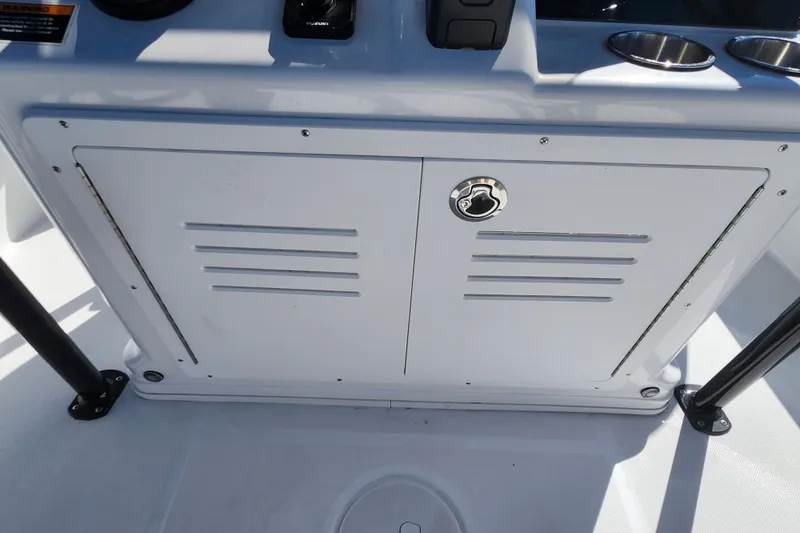 Slide: The Image of 2026 Savannah 210X boat console with storage compartment and cup holders. - 36