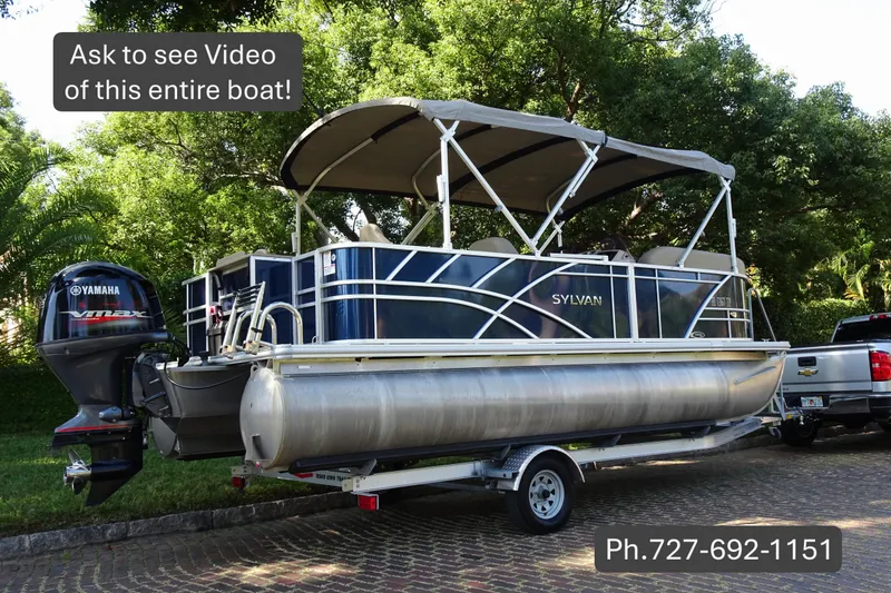 Slide: The Image of 2023 Sylvan Mirage Fish 820 Party Fish pontoon boat on trailer with Yamaha engine. - 1