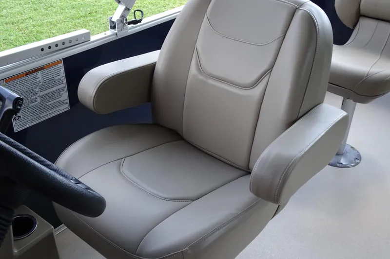 Slide: The Image of 2023 Sylvan Mirage Fish 820 Party Fish boat seat, beige upholstery, armrests, and steering wheel. - 14