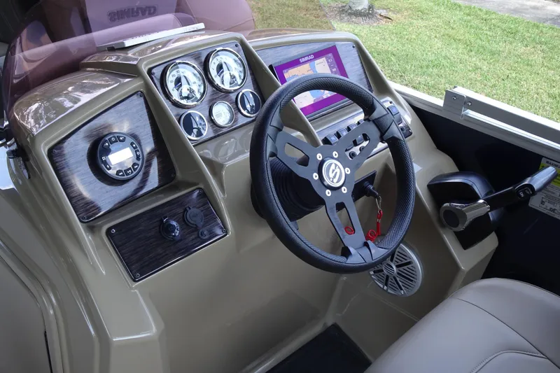 Slide: The Image of 2023 Sylvan Mirage Fish 820 Party Fish boat dashboard with steering wheel and controls. - 15