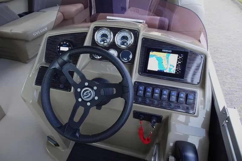 Slide: The Image of 2023 Sylvan Mirage Fish 820 Party Fish dashboard with steering wheel and navigation display. - 16