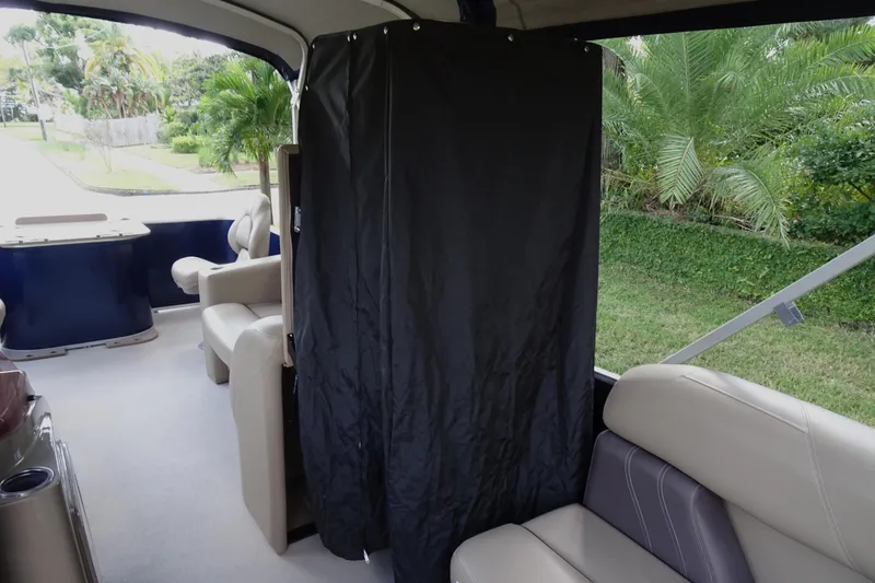 Slide: The Image of 2023 Sylvan Mirage Fish 820 Party Fish interior with seating and privacy curtain. - 18