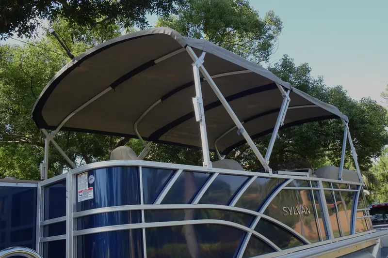 Slide: The Image of 2023 Sylvan Mirage Fish 820 Party Fish pontoon boat with canopy, surrounded by trees. - 7