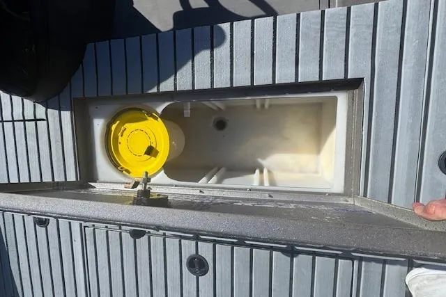 Slide: The Image of 2020 Lowe Stinger 175 boat deck with open storage compartment and yellow lid. - 7