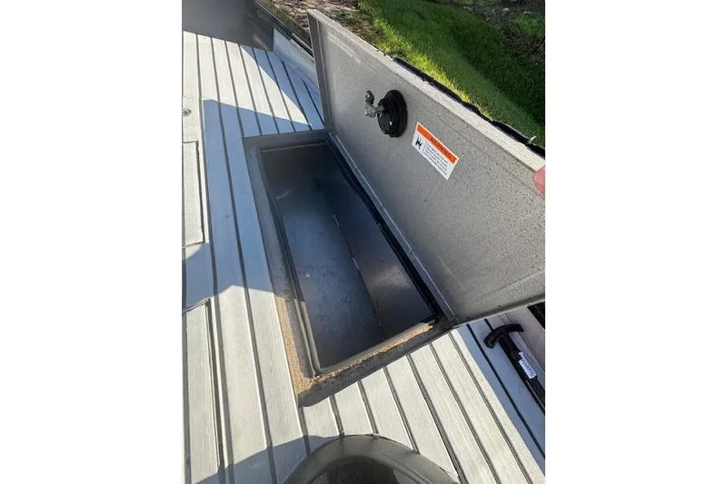 Slide: The Image of Open storage compartment on 2020 Lowe Stinger 175 boat deck. - 9