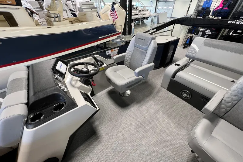 Slide: The Image of Interior of 2026 Crest Conquest 230 SLSC boat with modern seating and steering console. - 11