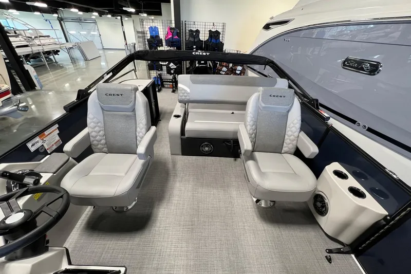 Slide: The Image of 2026 Crest Conquest 230 SLSC boat interior with modern seating and steering wheel. - 12