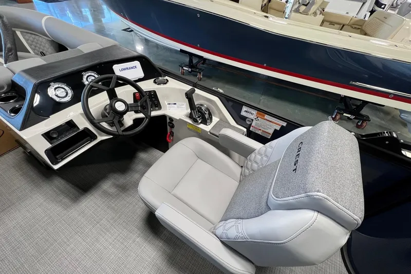 Slide: The Image of Interior of 2026 Crest Conquest 230 SLSC boat with steering wheel and controls. - 13