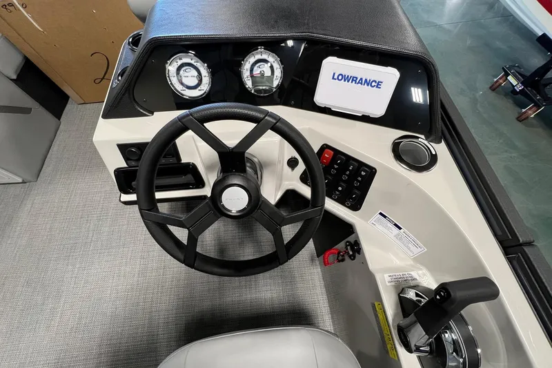 Slide: The Image of Steering console of 2026 Crest Conquest 230 SLSC with Lowrance display and controls. - 14