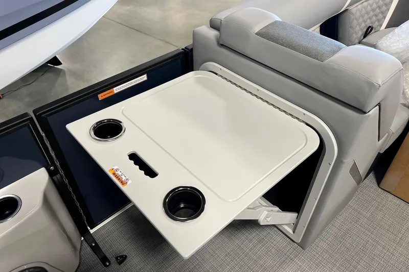 Slide: The Image of 2026 Crest Conquest 230 SLSC boat interior with foldable table and cup holders. - 15