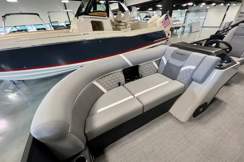 Slide: The Image of 2026 Crest Conquest 230 SLSC pontoon boat interior with modern seating and sleek design. - 19