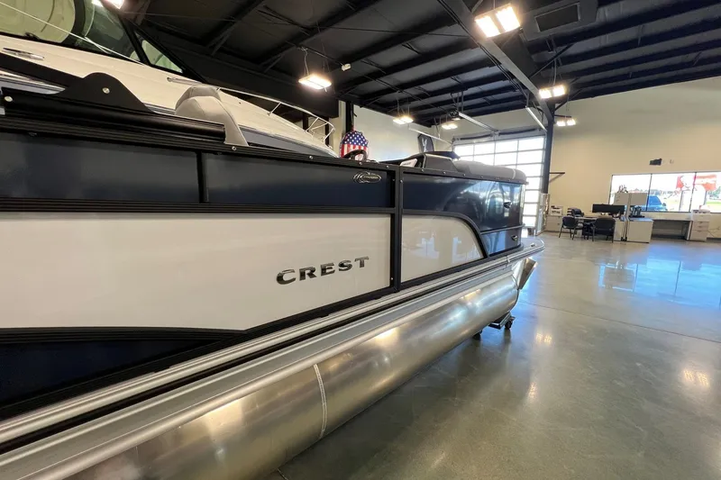 Slide: The Image of 2026 Crest Conquest 230 SLSC pontoon boat displayed in a showroom. - 3