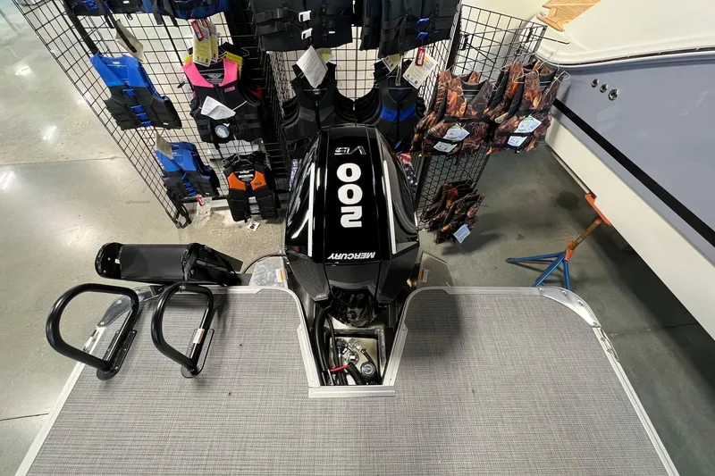 Slide: The Image of 2026 Crest Conquest 230 SLSC boat with Mercury 200 engine, displayed in showroom. - 8