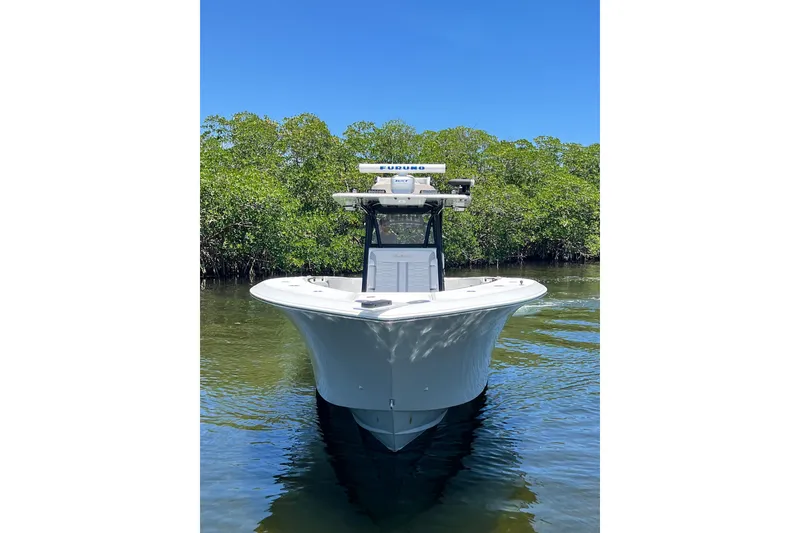 Slide: The Image of 2013 SeaHunter 39 Tournament boat on calm water, surrounded by lush greenery. - 10