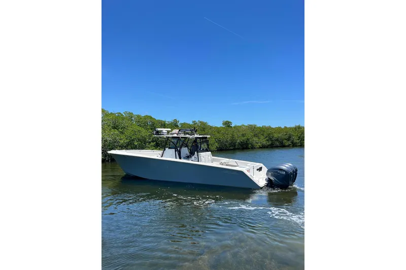 Slide: The Image of 2013 SeaHunter 39 Tournament boat on calm water under clear blue sky. - 6
