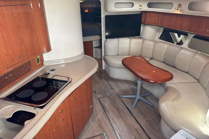 Slide: The Image of Interior of 1999 Sea Ray Sundancer 400 yacht with kitchen and seating area. - 14