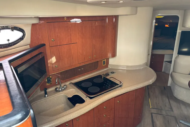 Slide: The Image of Interior of 1999 Sea Ray Sundancer 400 yacht with kitchen and seating area. - 15