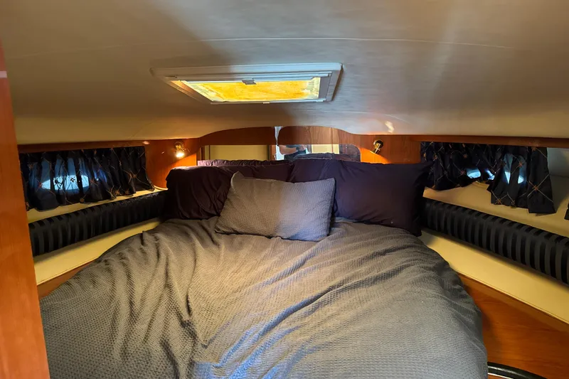 Slide: The Image of Cozy cabin interior of 1999 Sea Ray Sundancer 400 yacht with plush bedding. - 17