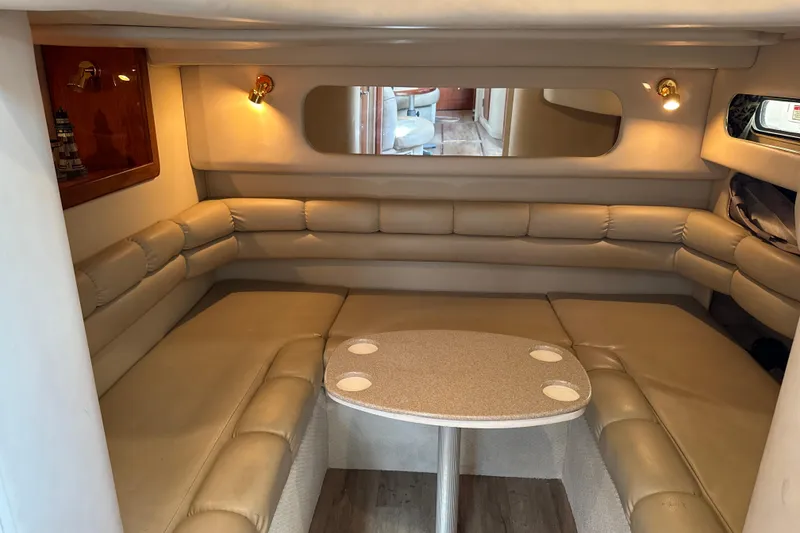 Slide: The Image of Interior of 1999 Sea Ray Sundancer 400 with beige seating and table. - 19