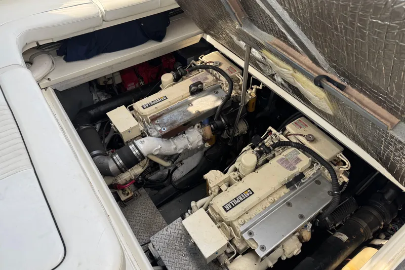 Slide: The Image of Engine compartment of a 1999 Sea Ray Sundancer 400, featuring twin diesel engines. - 27