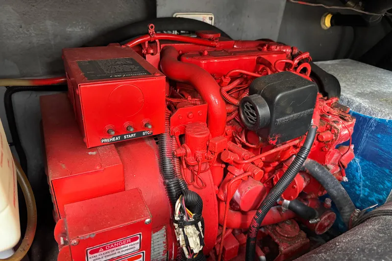 Slide: The Image of Engine compartment of a 1999 Sea Ray Sundancer 400, featuring a red marine engine. - 29