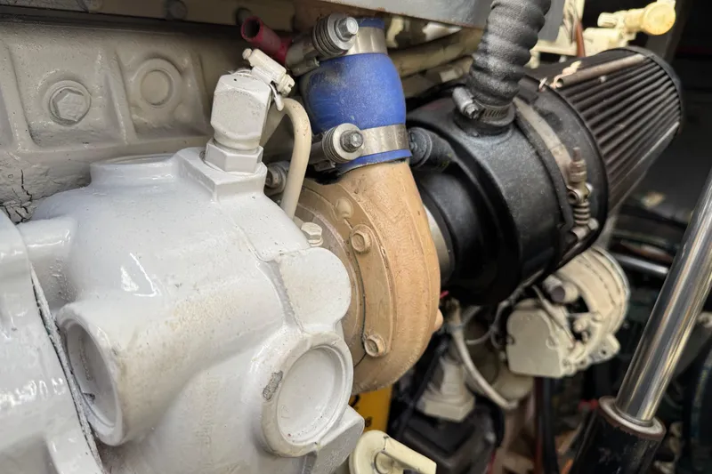 Slide: The Image of Engine components of a 1999 Sea Ray Sundancer 400 boat, featuring hoses and fittings. - 33