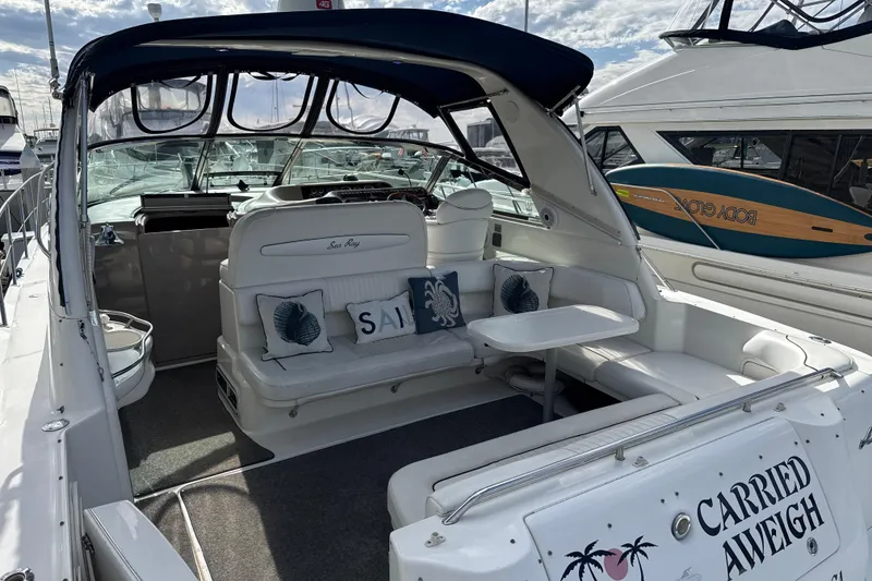 Slide: The Image of 1999 Sea Ray Sundancer 400 yacht with spacious seating and nautical decor. - 8