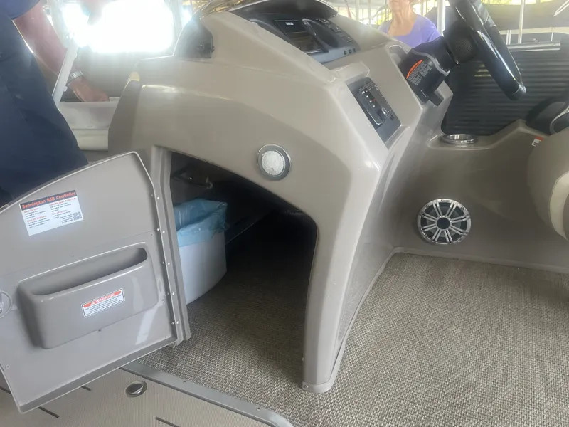 Slide: The Image of Interior of a 2020 Bennington SSRFBXP boat showing helm and storage area. - 10