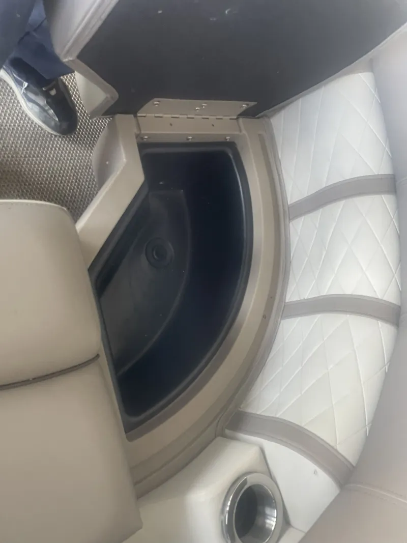 Slide: The Image of Bennington 2020 SSRFBXP boat interior with storage compartment and cushioned seating. - 16