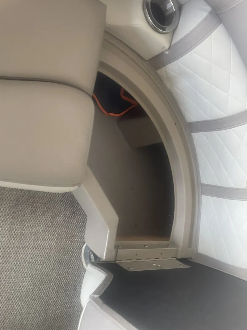 Slide: The Image of 2020 Bennington SSRFBXP boat interior with cushioned seating and storage compartment. - 17