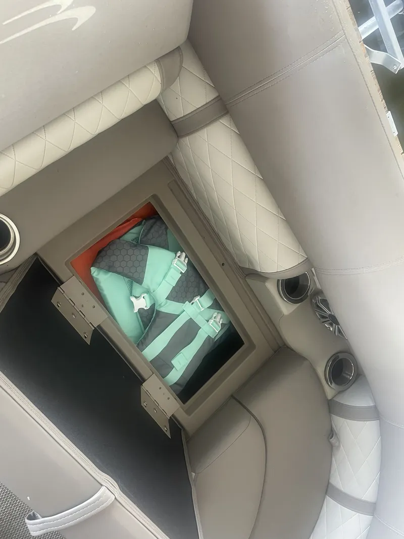 Slide: The Image of Interior of a 2020 Bennington SSRFBXP boat with storage compartment and life jacket. - 18