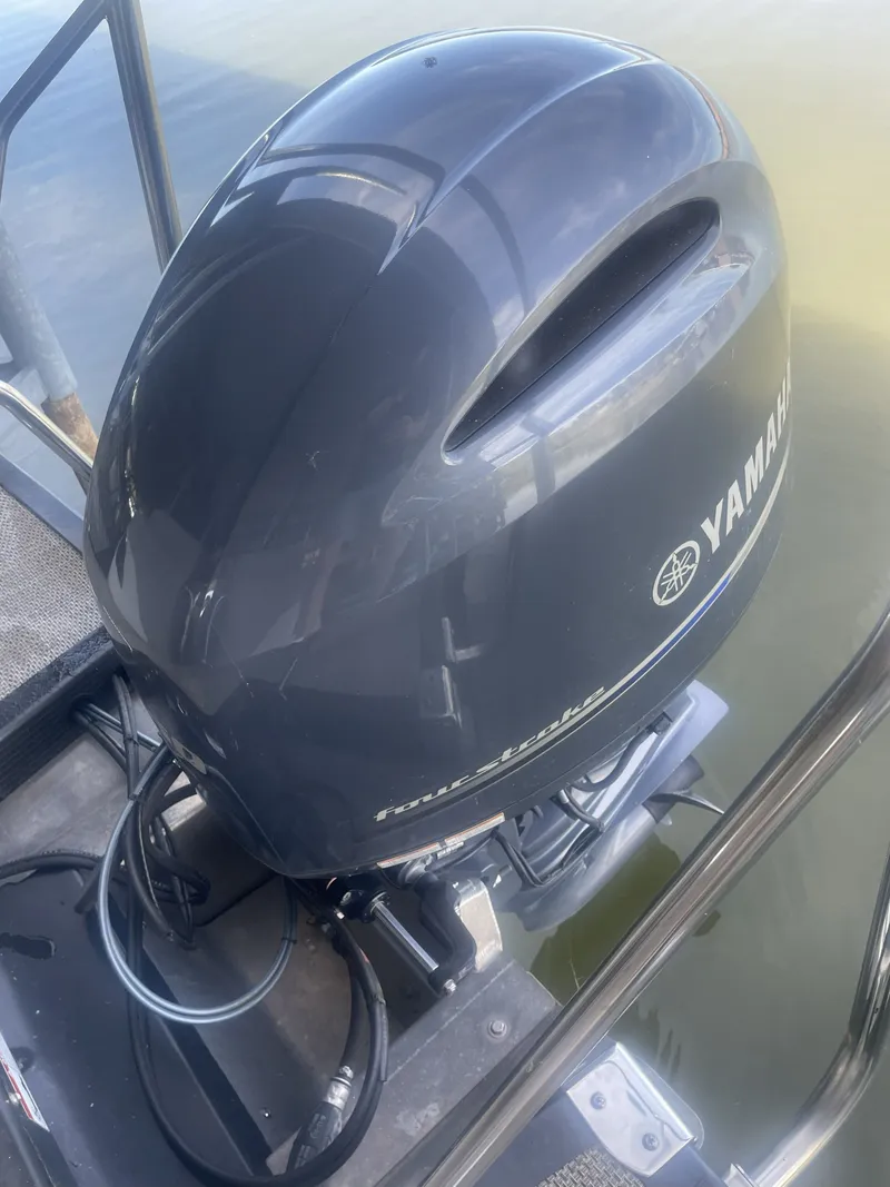 Slide: The Image of Yamaha outboard motor on 2020 Bennington SSRFBXP boat, docked by water. - 2