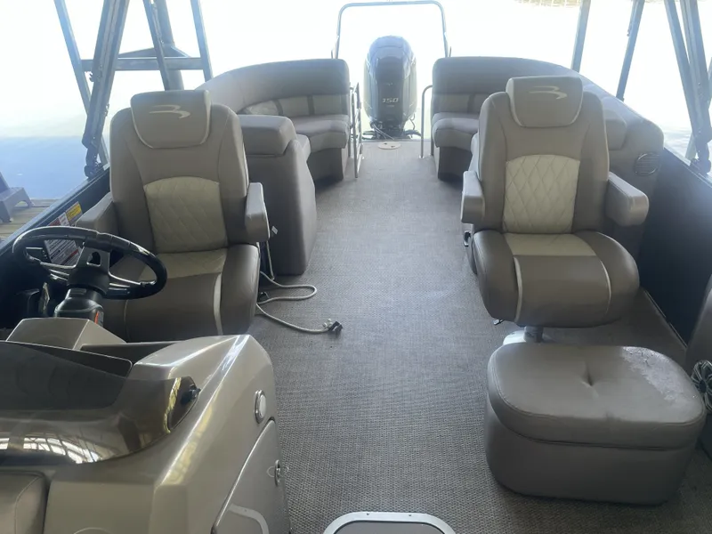 Slide: The Image of 2020 Bennington SSRFBXP boat interior with plush seating and steering console. - 28