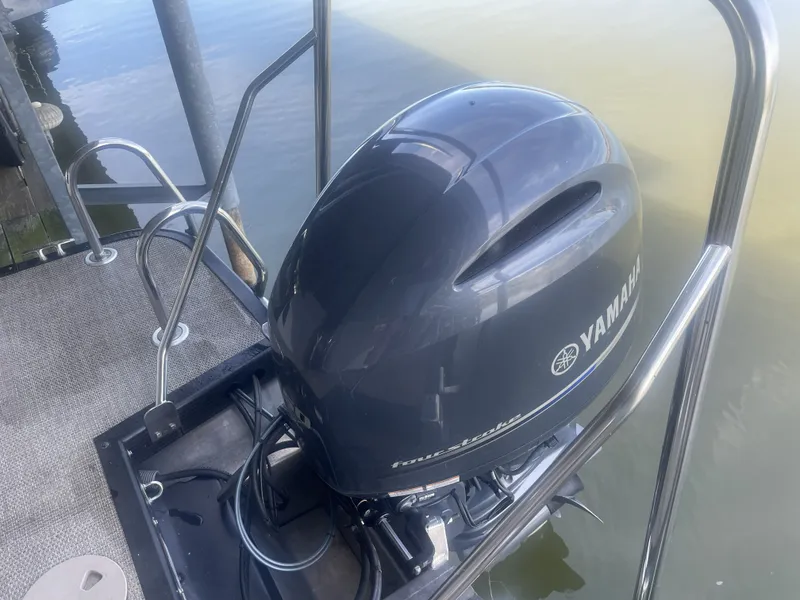Slide: The Image of Yamaha outboard motor on 2020 Bennington SSRFBXP boat, docked by water. - 3