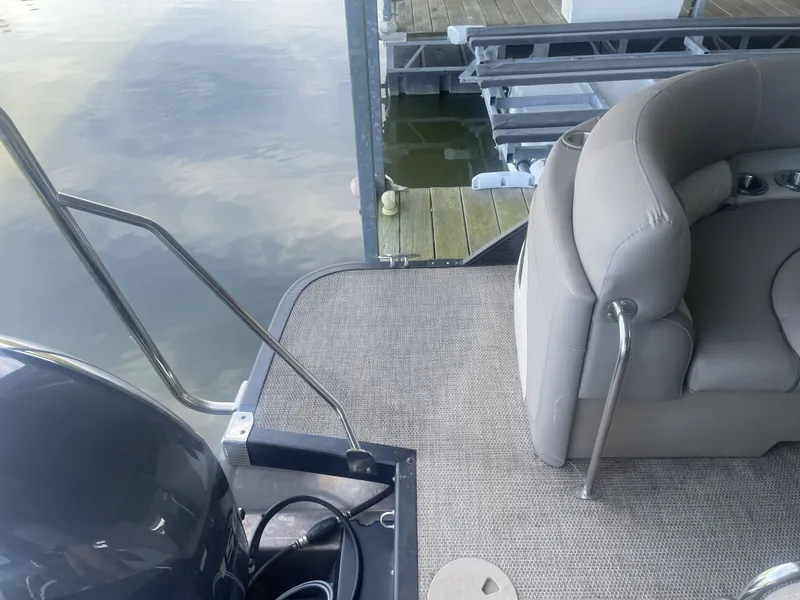 Slide: The Image of 2020 Bennington SSRFBXP boat interior with seating and dock view. - 30