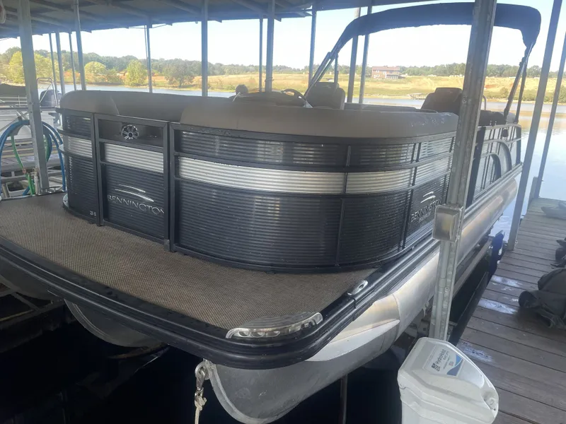 Slide: The Image of 2020 Bennington SSRFBXP pontoon boat docked in a marina setting. - 32