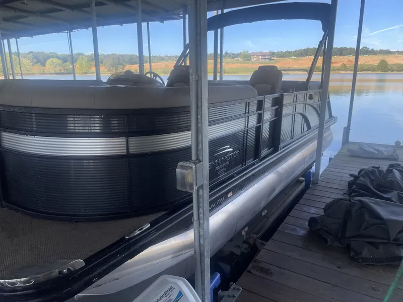 Slide: The Image of 2020 Bennington SSRFBXP pontoon boat docked by a serene lake. - 33