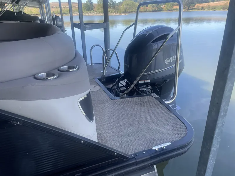 Slide: The Image of 2020 Bennington SSRFBXP boat with Yamaha motor, docked on a calm lake. - 35