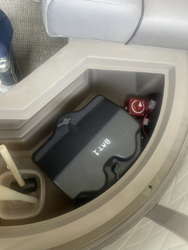 Slide: The Image of Battery compartment of a 2020 Bennington SSRFBXP boat, featuring a black battery box. - 4