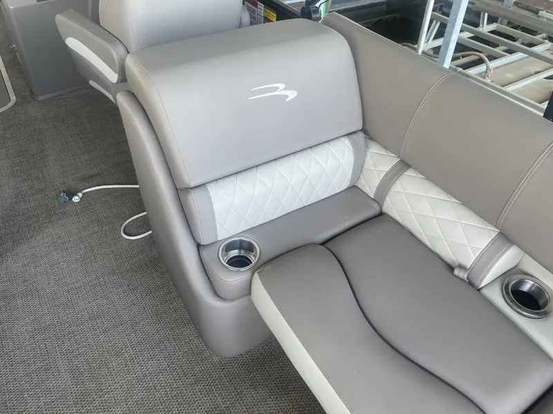 Slide: The Image of 2020 Bennington SSRFBXP boat interior with gray and white cushioned seating and cup holders. - 40