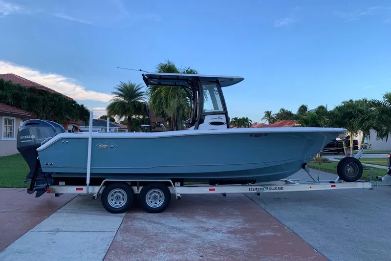 The Image of 2022 Sea Hunt Gamefish 25 boat on trailer in residential driveway. - 0